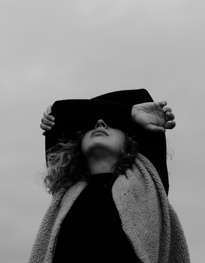 Black and white photo of a woman struggling with mental health