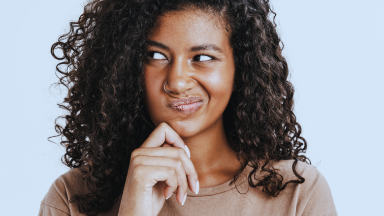 Close up of a beautiful woman's face contemplating and in deep thought.